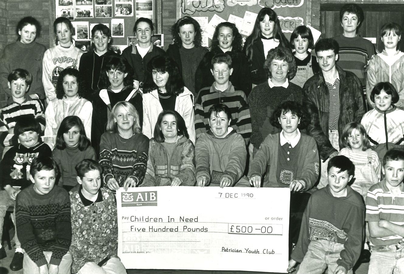 A big group of club members holding up a £500 cheque made out to Children in Need