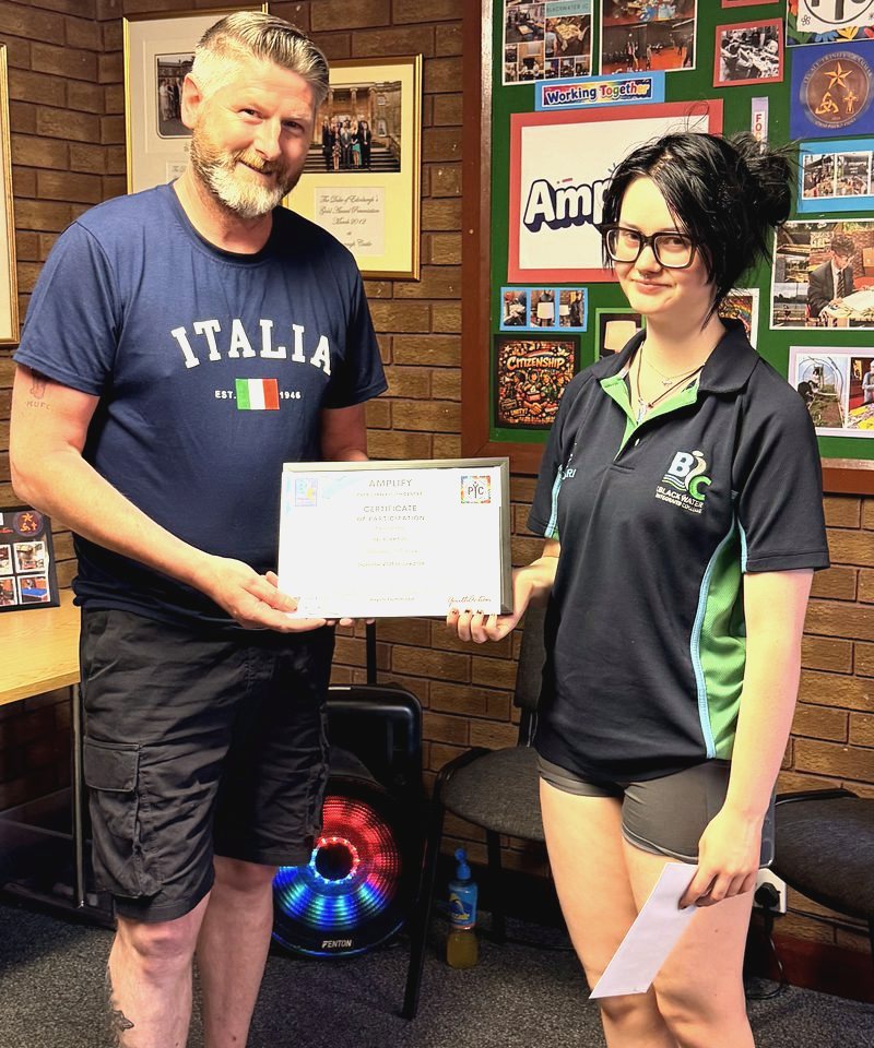 A member receiving an Amplify programme certificate at the Centre