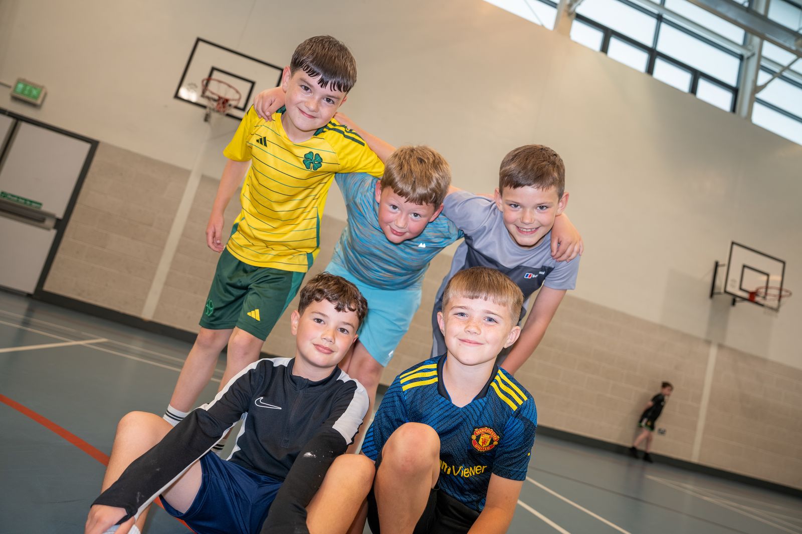Five boys together in the sports hall